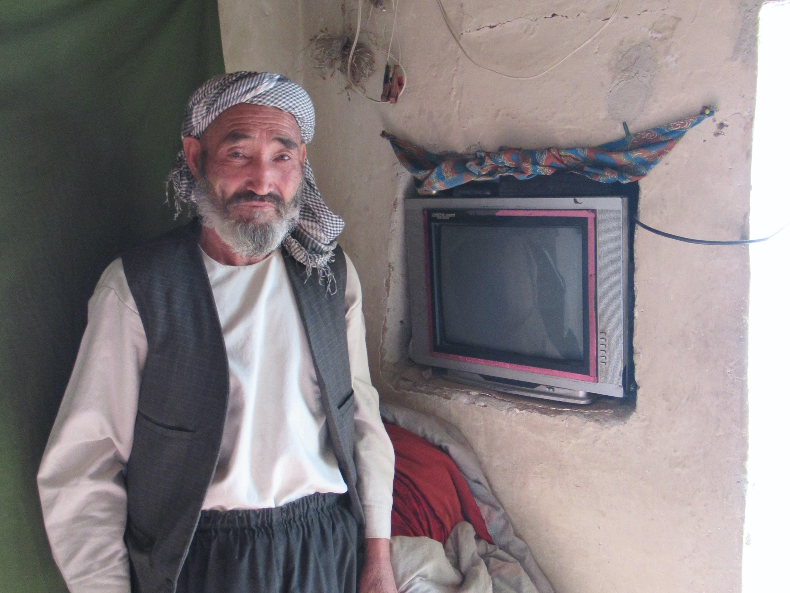 This man is proud that he has access to electricity to watch TV every now and then.