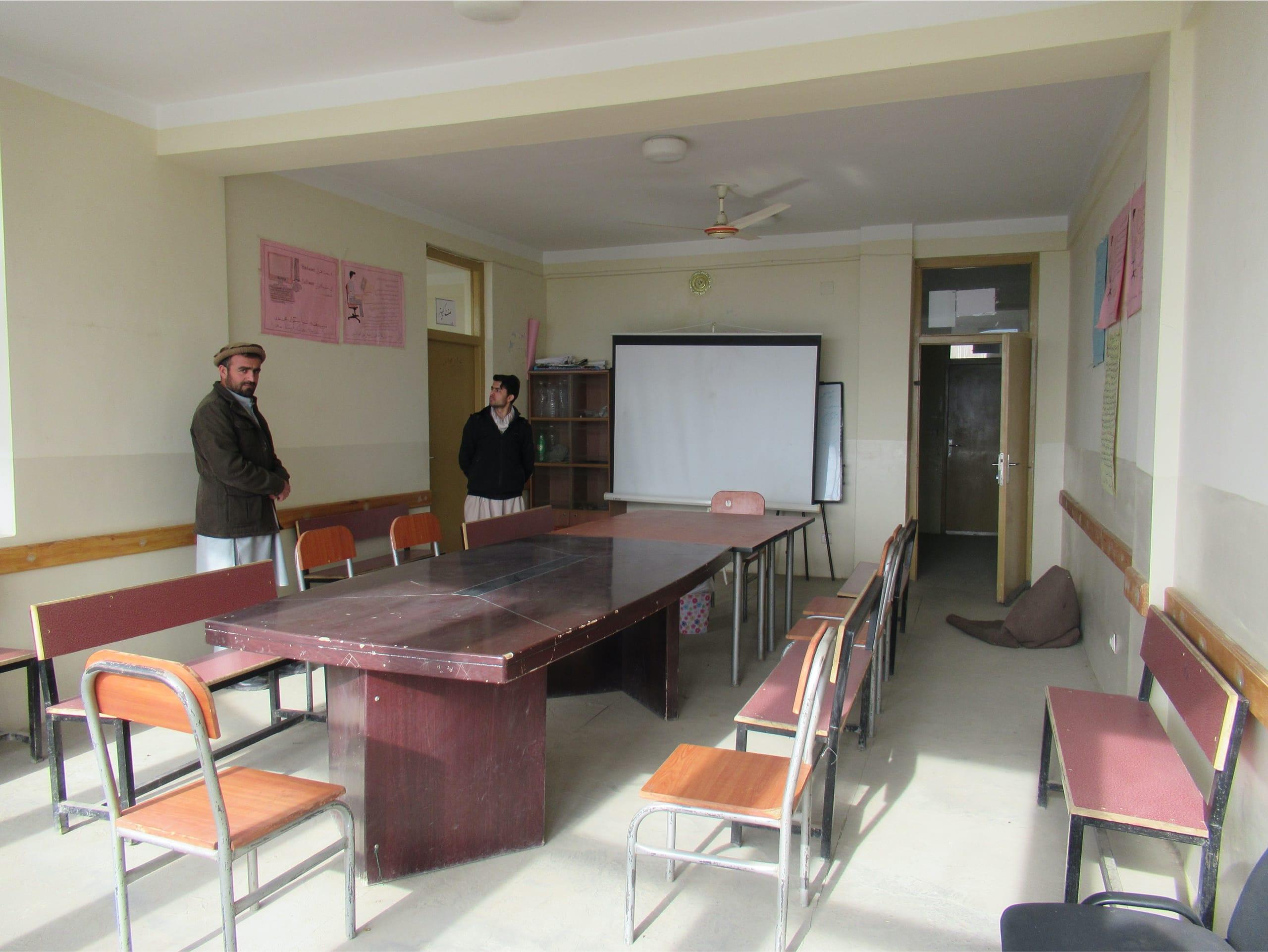 This classroom is equipped with a fan and a projector, allowing the students to learn most effectively.